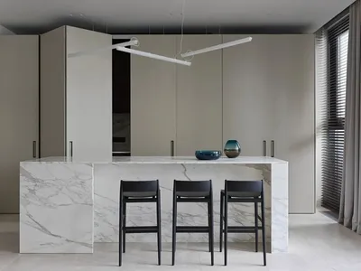 Modern kitchen with marble countertops and glass elements