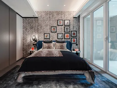 Modern bedroom with a bed featuring leather upholstery, metal headboard, and glass nightstands.