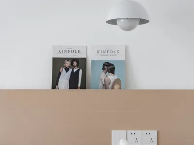 A modern minimalist bedroom featuring sophisticated furniture with wooden nightstand