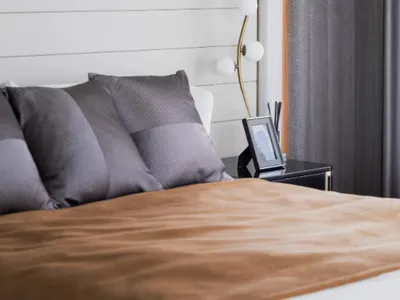 Modern minimalist bedroom with textured white paneled wall