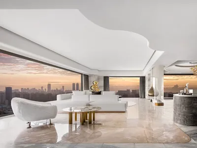Modern minimalist living room with city view, featuring marble floor, white furniture, and gold accents