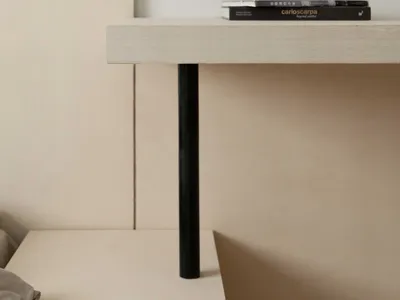 Contemporary minimalist bedroom featuring a wooden nightstand with black legs.