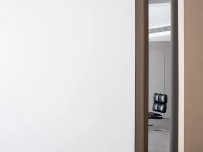 Modern minimalist bedroom with white walls and furniture