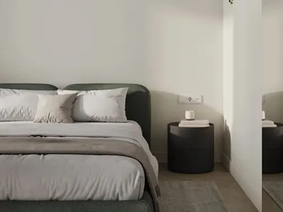 A minimalist bedroom with neutral colors and a black hanging plant.