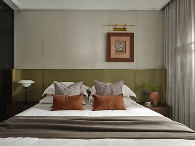 Contemporary bedroom with modern furniture, featuring fabric upholstery and minimalist design.