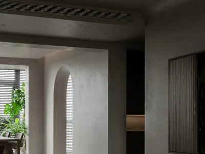 Minimalist living room featuring concrete elements.
