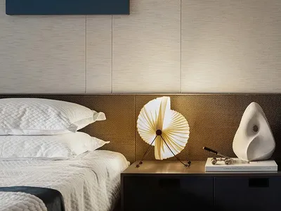 Modern minimalist bedroom with metal headboard and wooden accents.