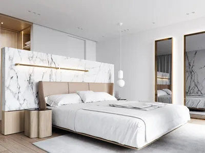 Modern bedroom featuring a marble accent wall and bed platform.