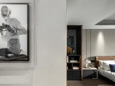 Modern bedroom with minimalist design featuring neutral-toned furniture and a cozy atmosphere.