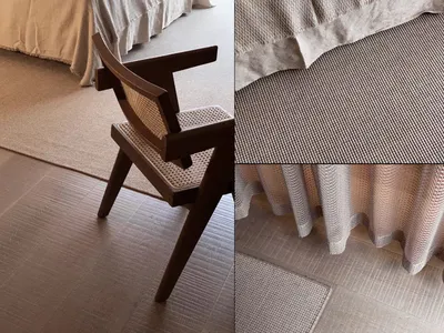 A modern brown wooden armchair with woven backrest and seat, positioned on a grey textured floor covered with light grey wove