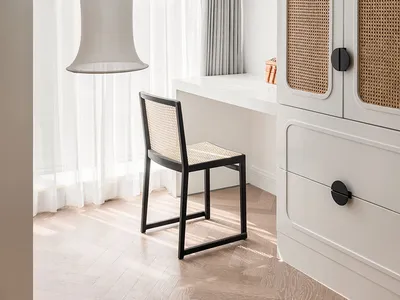 A minimalist home office with light wood cane blinds, white curtains, and white walls, featuring solid white furniture and a