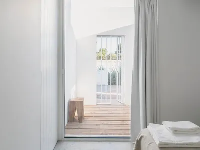 Minimalist bedroom featuring concrete and wooden elements
