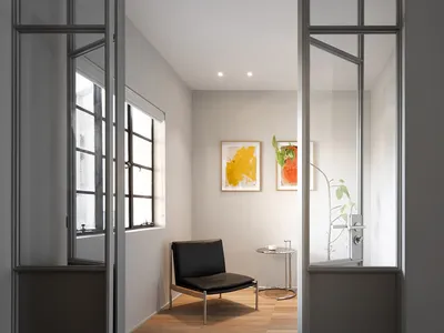 Industrial-style living room with metal-framed glass doors, minimalist furniture, and modern artwork.