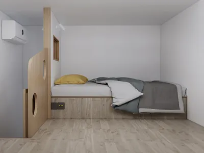 A minimalist bedroom featuring wooden furniture and a bed with a yellow pillow and grey blanket.