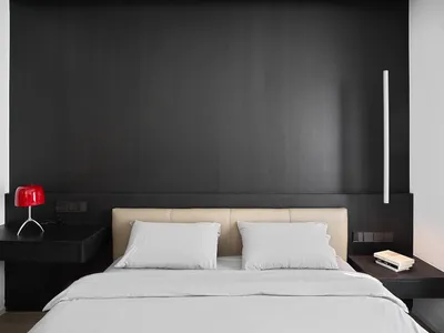 Modern bedroom with white bedding, beige headboard, and minimalist design.