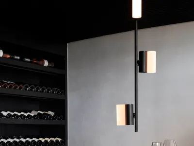 A minimalist bar with a marble countertop and modern lighting fixtures.
