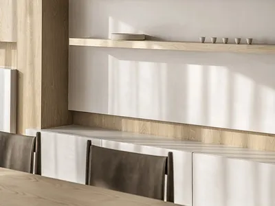 Minimalist kitchen with concrete countertops, wooden cabinets, and metal accents.