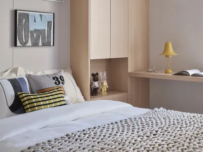 Modern minimalist bedroom featuring wooden walls and a comfortable bed.