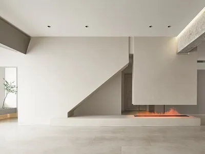 A minimalist living room with a concrete fireplace and floors.