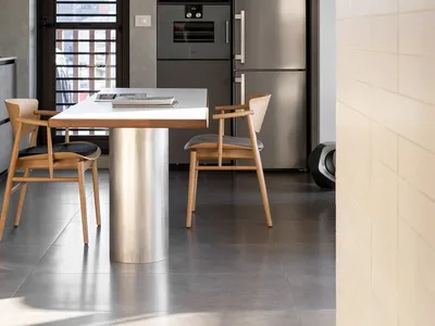 Modern kitchen with wooden chairs and metal dining table
