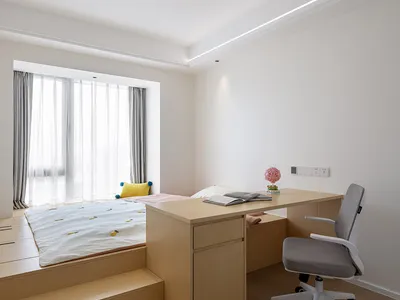 A modern minimalist bedroom with wooden furniture, a white bed, and gray curtains.