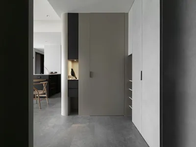 Modern minimalist kitchen with concrete flooring and minimalist design elements.