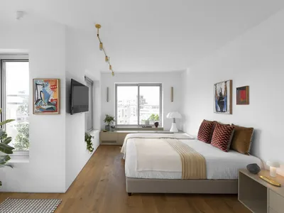 A minimalist bedroom featuring modern materials and a cozy atmosphere.