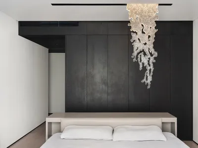 Modern minimalist bedroom featuring a metallic texture headboard with a contemporary design.
