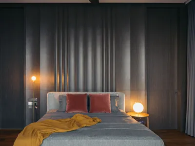 A contemporary bedroom featuring a bed with neutral-toned bedding and a minimalist design.