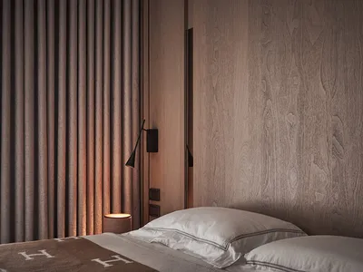A minimalist bedroom featuring wooden textures and a cozy bed setup.