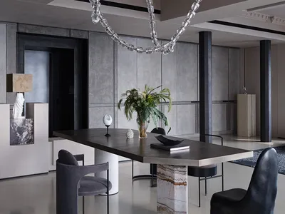 Modern restaurant interior with concrete floors and walls, minimalistic design, and contemporary art installations.