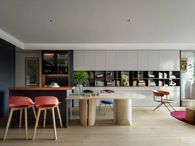 Modern kitchen with a white marble countertop and black cabinets.