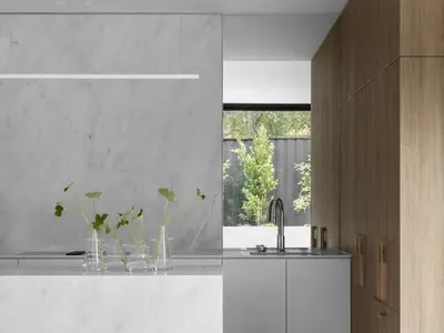 Modern residential kitchen with marble countertops and oak cabinets