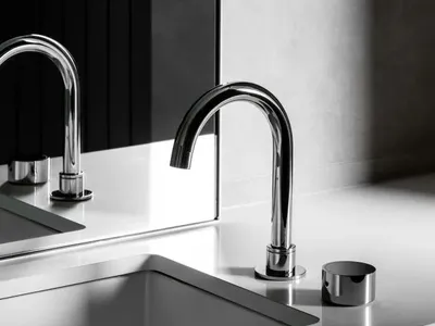 Modern kitchen with a sleek, metallic sink and minimalist design.