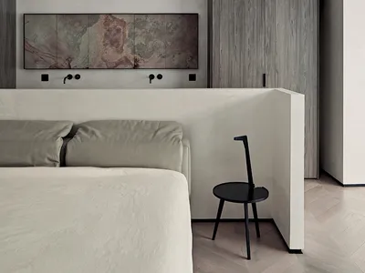 A modern bedroom features concrete walls and wooden furniture.