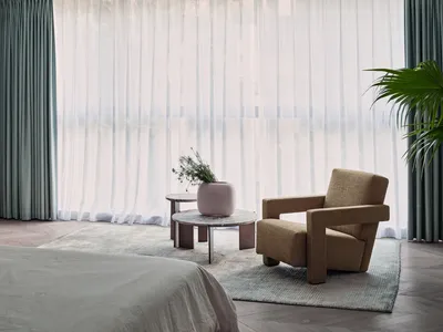 A stylish modern bedroom with luxury furnishings and minimalistic decor.