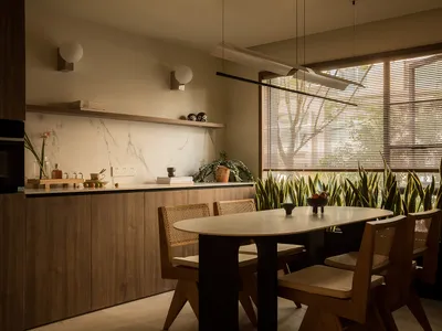 A modern kitchen dining room with a marble countertop and wooden furniture.