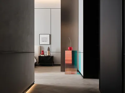 A minimalist bedroom with concrete and glass elements.