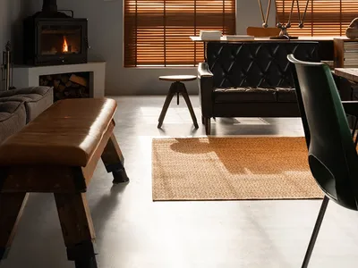 A living room with an industrial aesthetic featuring wooden elements and a fireplace.