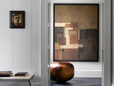 A minimalist living room decorated with abstract wall art.