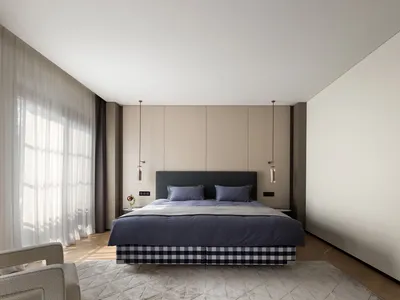 A modern bedroom with neutral color palette and textile accents.