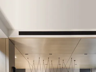 A modern kitchen featuring metallic cabinets and a concrete countertop.