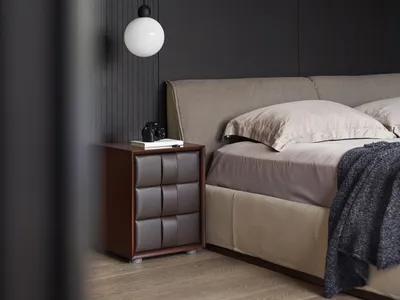 Minimalist bedroom with a bed, nightstand, and wall light fixture