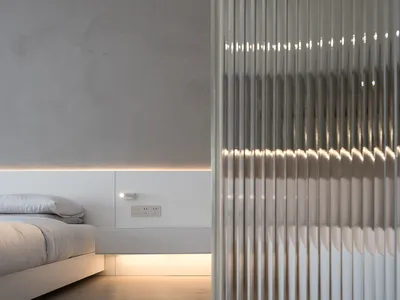 Minimalist bedroom with concrete elements and ambient lighting