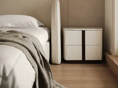 Modern minimalist bedroom with a wooden floor, a white bed with a light-colored blanket, and a white nightstand with marble t