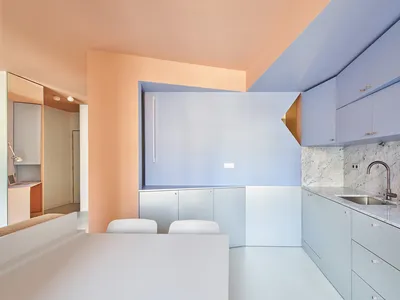 A modern minimalist kitchen with concrete finishes and a minimalist design.