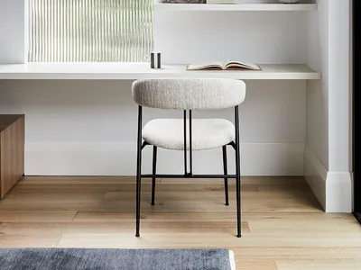 Industrial home office with a glass window, featuring minimalistic design and functional workspace.