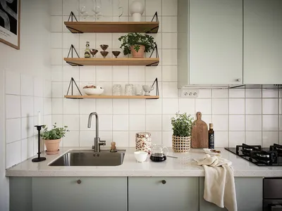 Modern, minimalist residential kitchen featuring ceramic tiles, wood, glass, and stainless steel.