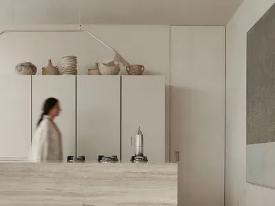 Modern kitchen interior with minimalist design, featuring marble countertops and a sleek, open layout.
