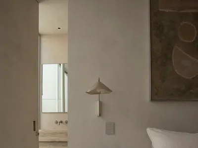Minimalist bedroom interior design with concrete materials.